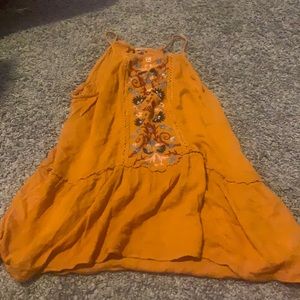 Orange tank top with flowers on it